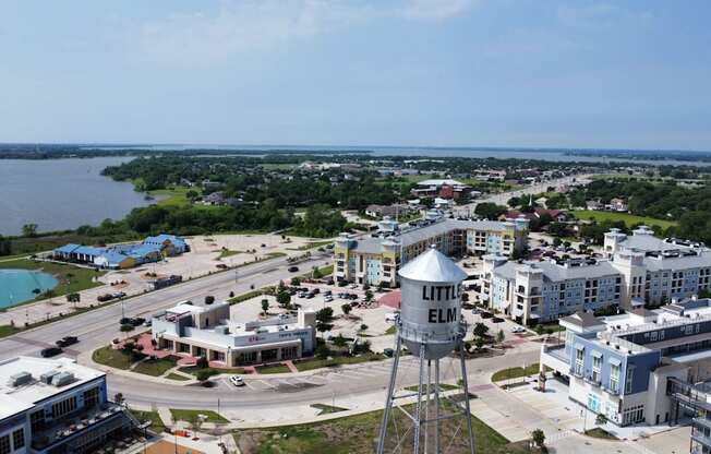 an aerial view of a city with buildings and a water tower