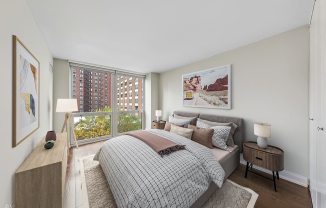 a bedroom with a bed and a large window