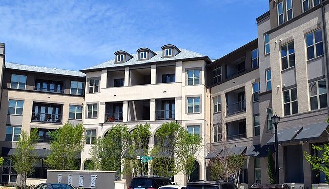 Building with balconies and a sidewalk at Civic at Frisco Square Apartments, Frisco, Texas