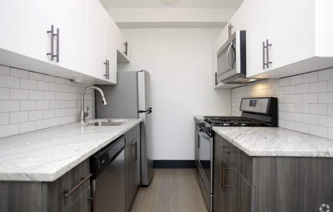 The Edison apartments modern kitchen with custom cabinetry and stainless appliances