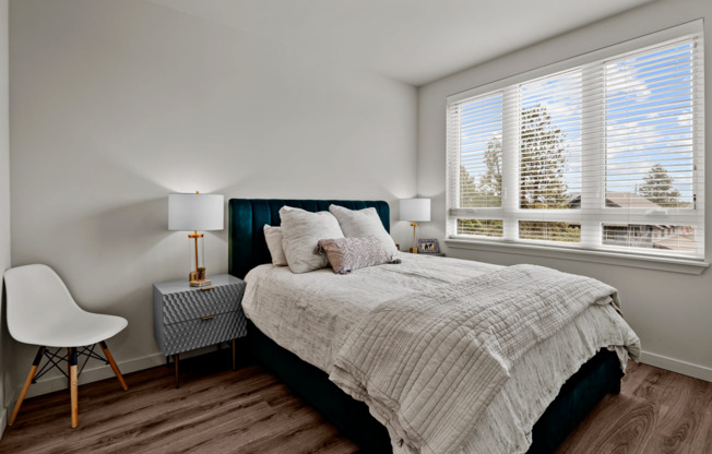 spacious bedroom with oversized windows allowing natural light