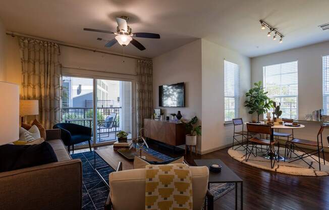 A living room with a brown couch, a yellow chair, and a television.