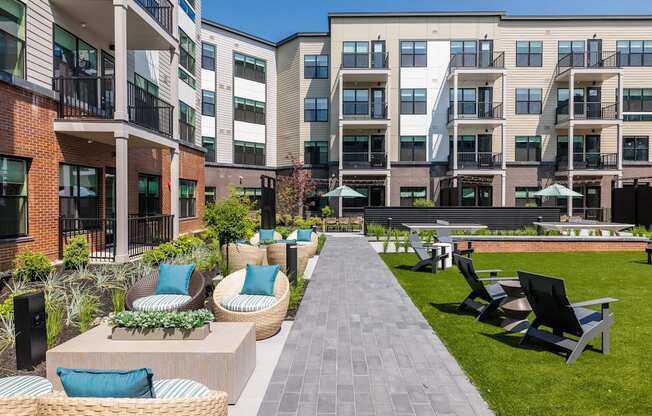 A sunny day at a modern apartment complex with a well-kept courtyard.