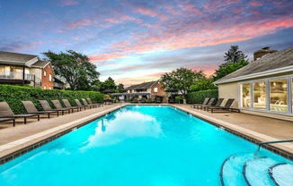 Apartments in Geneva, IL for Rent- Ashford at Geneva- A long rectangular swimming pool with a blue tinted water.