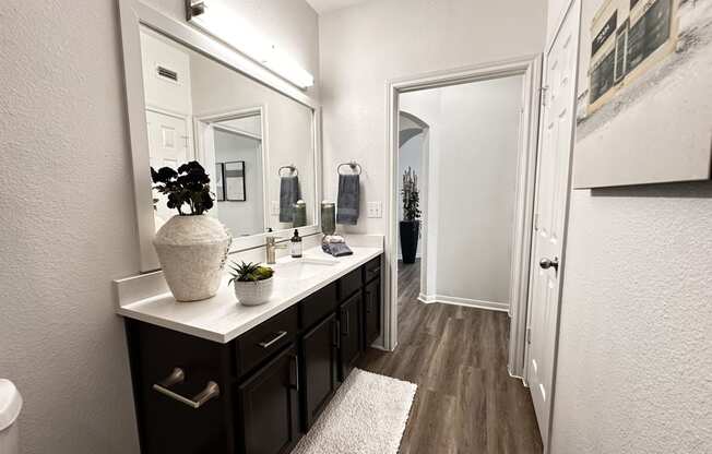 an empty bathroom with a large mirror and a sink