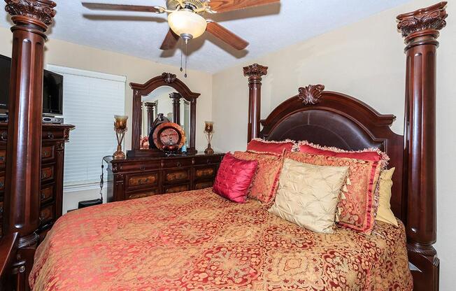 a bedroom with a large red chair in a room