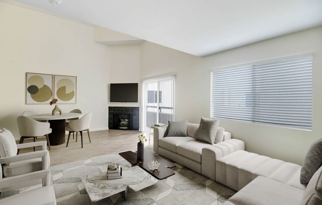 a living room with a white couch and a table with chairs