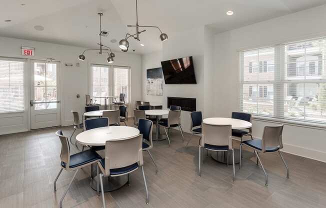 a dining room with tables and chairs and a fireplace