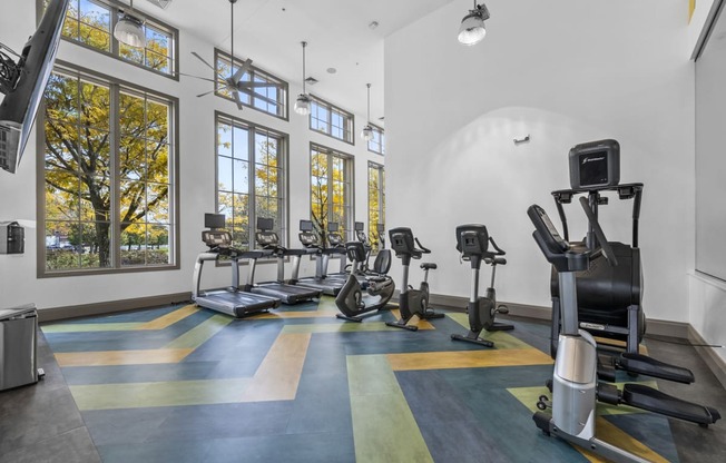 a workout room with treadmills a  at Harbor Pointe, Bayonne, NJ, 07002nd elliptical trainers