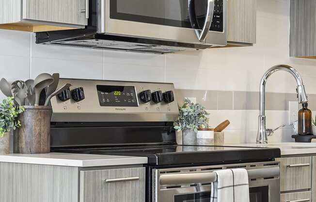 a kitchen with stainless steel appliances and a black stove