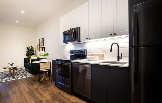 a kitchen with a sink and a refrigerator at The Irvine, Pennsylvania, 19143