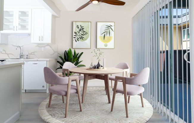 a dining room with a round table and pink chairs