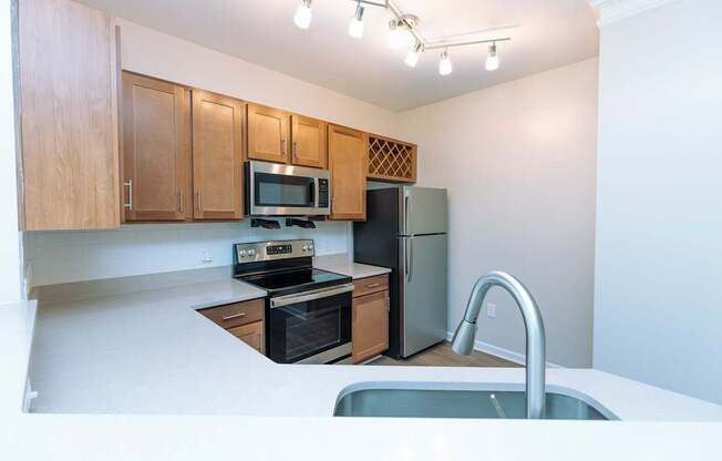 A kitchen with wooden cabinets and a black stove top oven.