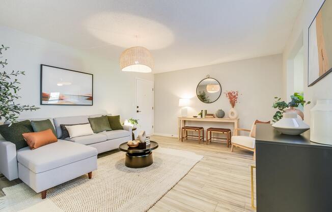 Platinum living room interior with area carpeting, couch and furniture at The Arbor in Blue Springs