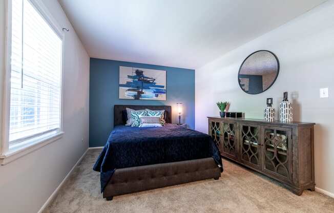 Spacious bedroom with a window at Ashton Brook Apartments