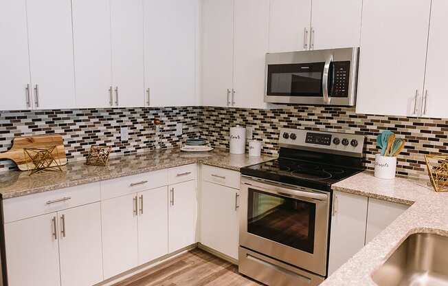 Kitchen with tile backsplash at Sycamore at Tyvola, Charlotte, North Carolina