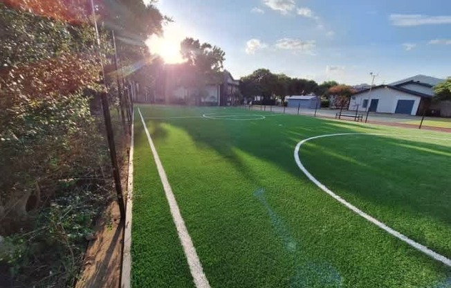 A sunny day at the soccer field with a clear blue sky.
