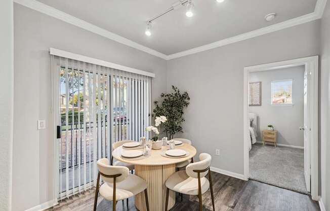 A dining room with a round table and chairs.