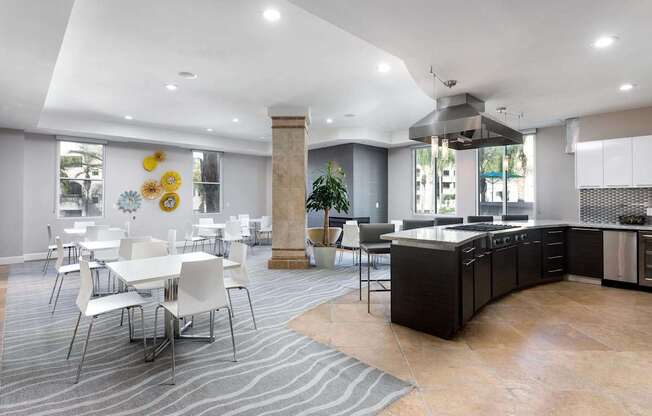 A modern kitchen and dining area with a large island and chairs. at La Jolla Crossroads Apartments, San Diego, 92122