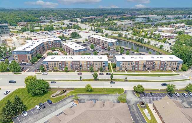 A large building complex with a parking lot in front.