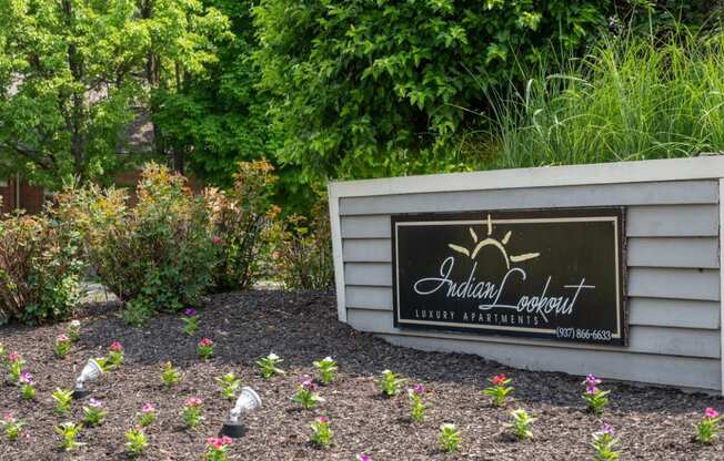 a garden with flowers and a sign that says adelaide garden