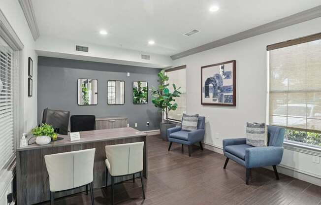 A leasing office with a desk and chairs at Encore at Buckingham Apartments in Richardson, TX
