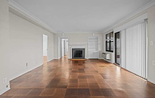 a large living room with a fireplace and a wooden floor