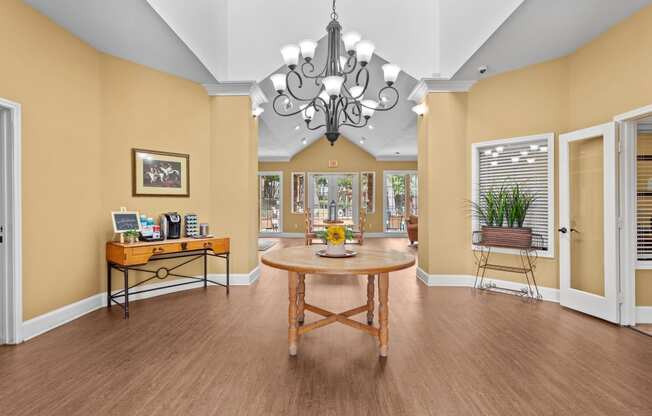 a dining room with a table and a chandelier