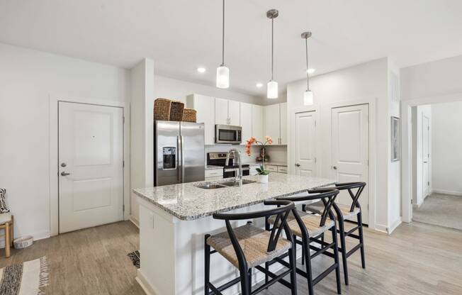 a kitchen with a marble counter top and bar stools