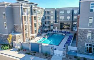 A large apartment complex with a pool in the middle.