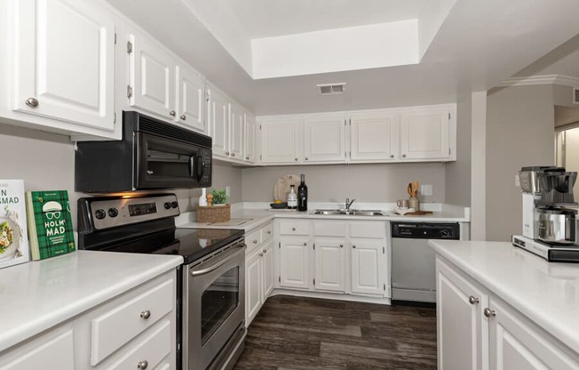 Model apartment kitchen with white cabinets and appliances at Saratoga Ridge, Phoenix, Arizona