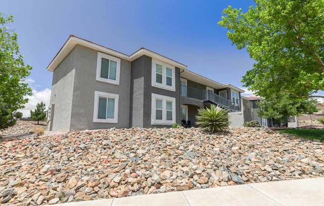 A modern two-story house with a stone foundation.