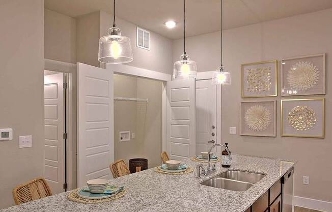 a kitchen with a sink and a counter top at Hunters Creek Apartments, Denton Texas