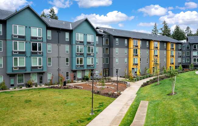 an exterior view of an apartment building on a sunny day
