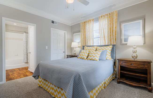 a bedroom with a large bed and yellow curtains