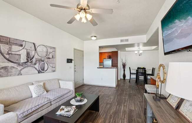 A living room with a grey couch and a coffee table.