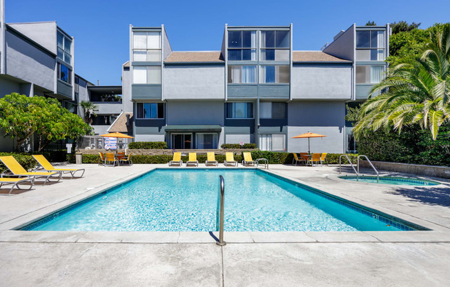 a swimming pool in front of an apartment building