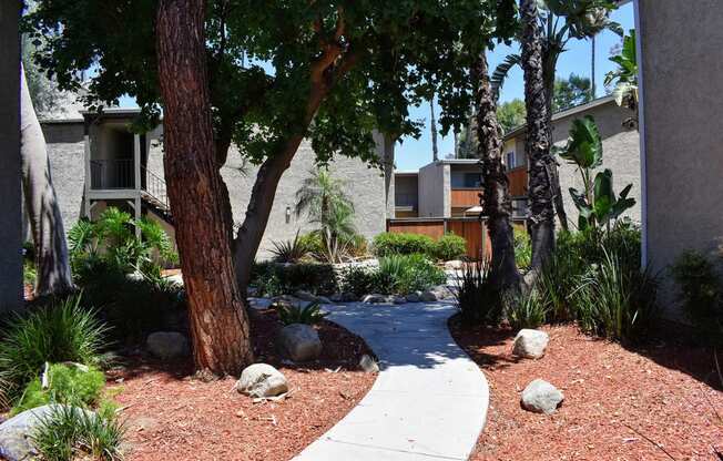 Buildings with sidewalk path and lush landscaping