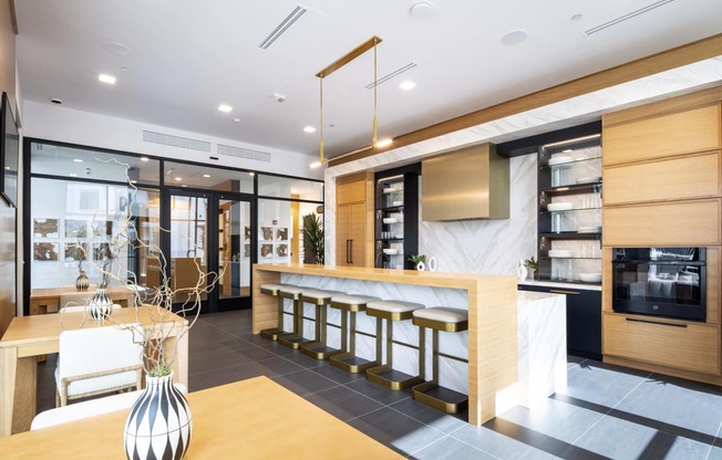 a kitchen and dining area with a bar and a table with chairs