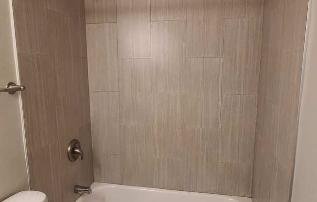 a bathroom with a toilet and a bath tub and a shower curtain
