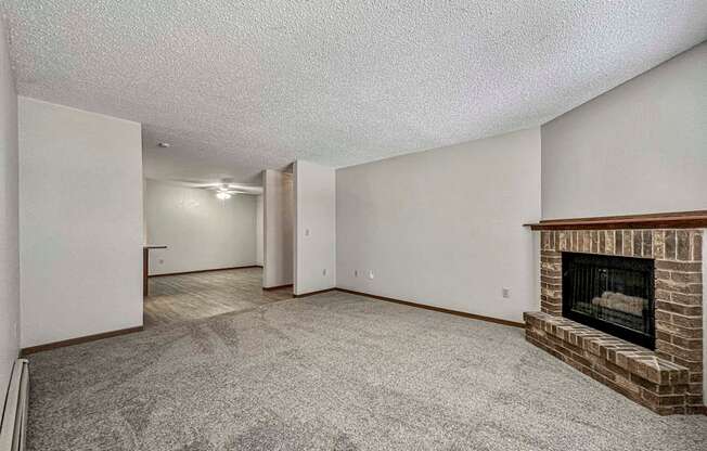a living room with a fireplace and a carpeted floor at Creekstone Falls, South Dakota, 57106