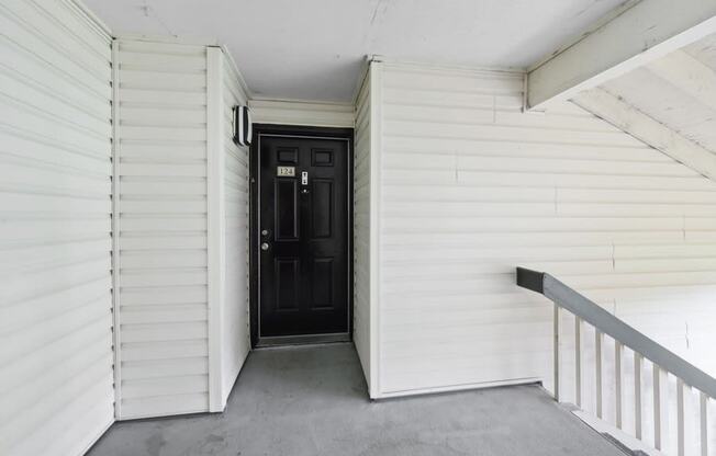 the entrance to a white building with a black door