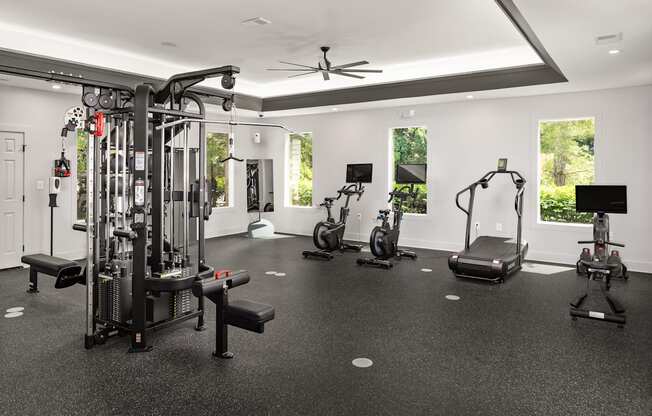 a gym with weights and cardio equipment in a luxury home