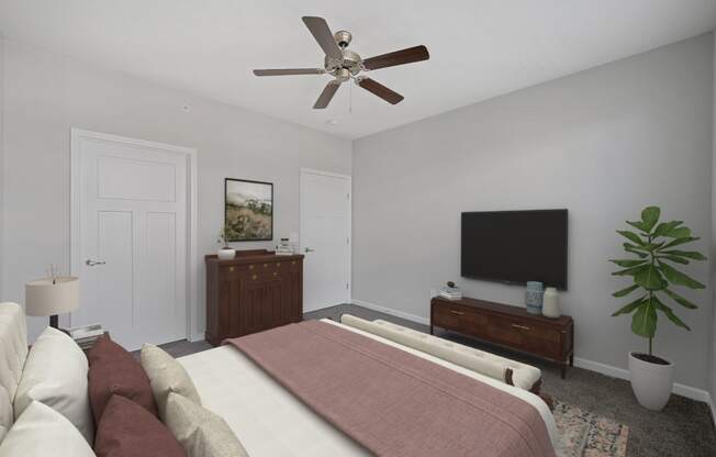 a bedroom with a large bed and a ceiling fan