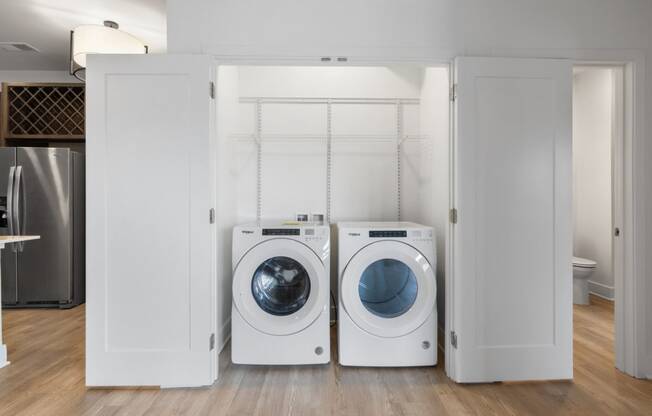 a washer and dryer in a white closet