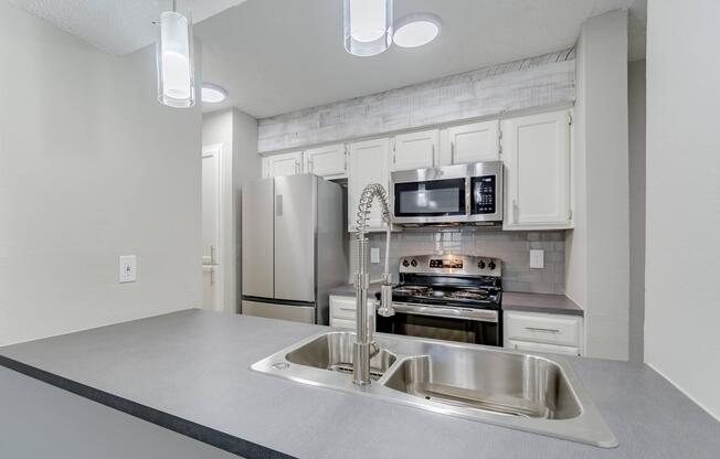 a kitchen with a stove and a sink