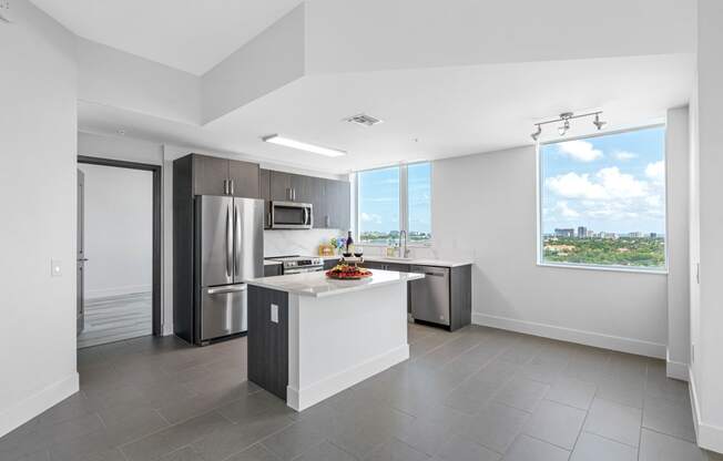 an open kitchen with stainless steel appliances and a large window