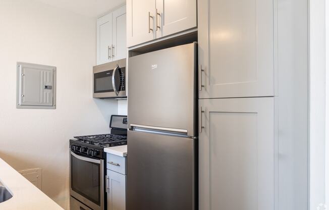 a kitchen with stainless steel appliances and a refrigerator