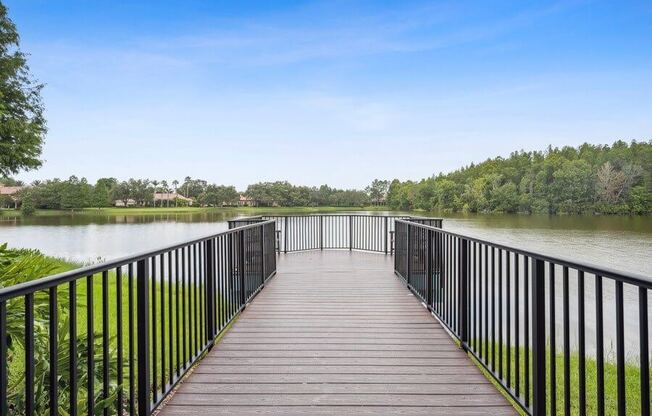 Long wooden dock over pond with look out point