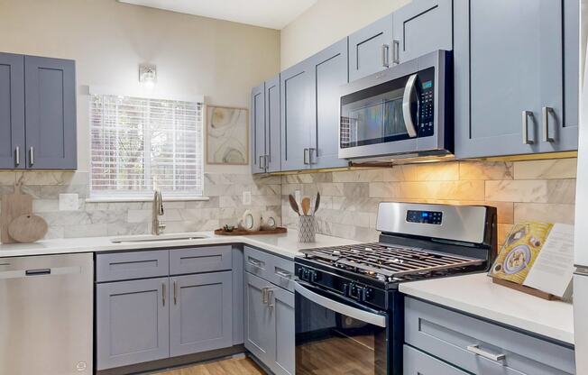 Remodeled kitchen with gas stove and a microwave